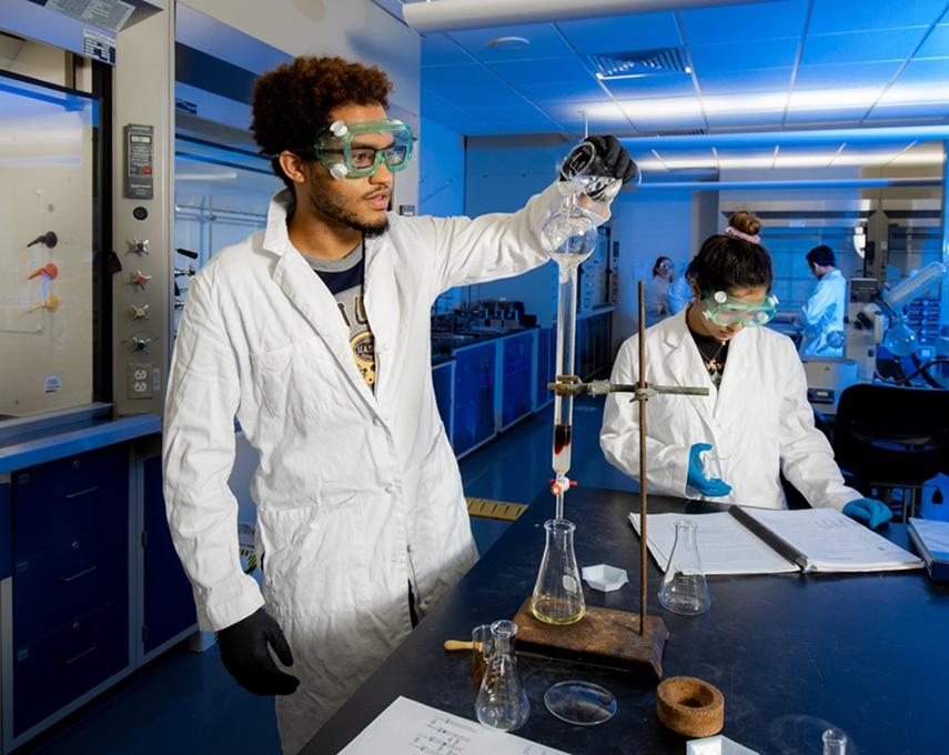 Students conduct an experiment in a chemistry lab