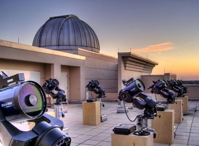 On top of the building at dusk, telescopes ready for use